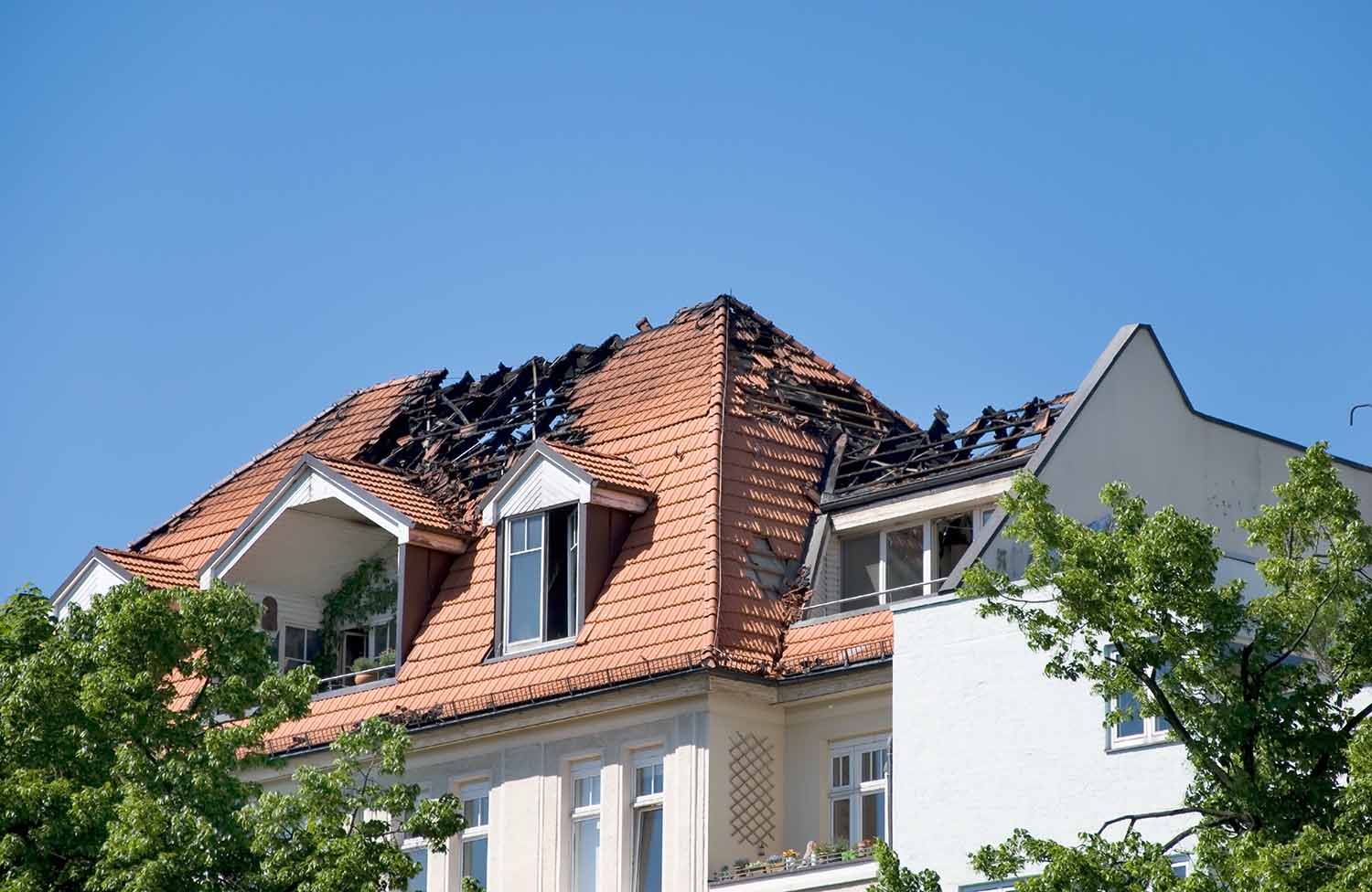 Hus med ødelagt tak etter brann